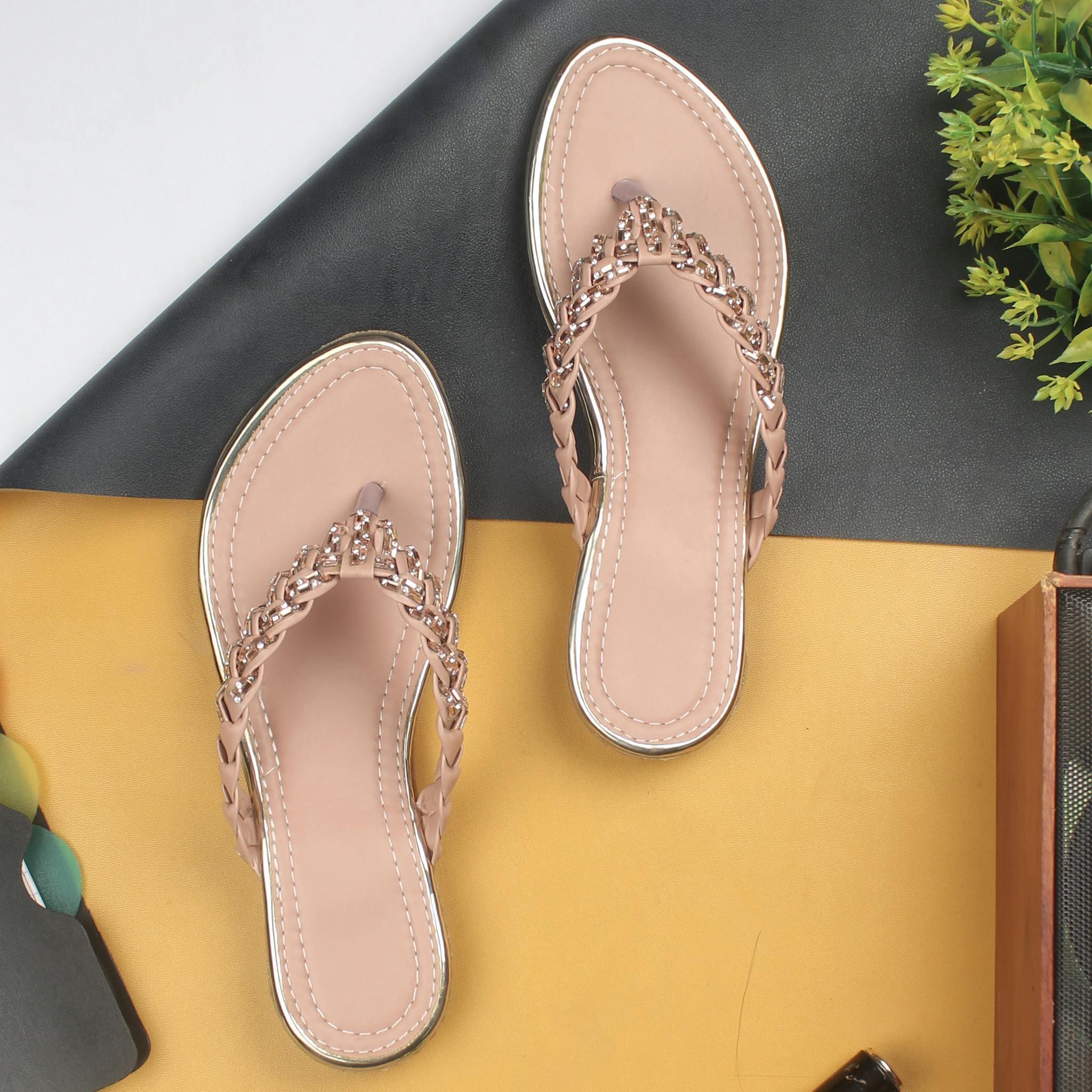 A pair of fashionable women's sandals showcased on a vibrant and stylish background setting.